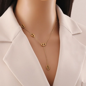 Detailed view of a gold-plated stainless steel Y-shaped tassel necklace on a model