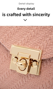 Macro view of pink woven leather texture and elegant gold metallic rectangular clasp