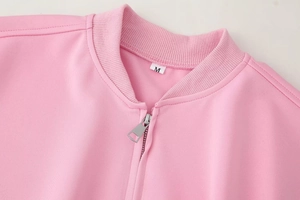Detail of pink bomber jacket neckline with high-quality zipper and size M label
