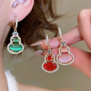 Detailed view of 14k gold plated gourd earrings with colorful resin and zircons