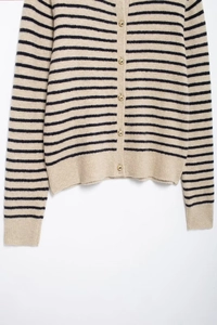 Detail of striped knit cardigan with round neck and premium gold metallic buttons