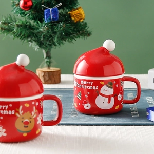 Red Christmas ceramic mugs with Santa hat lids featuring snowman and reindeer patterns