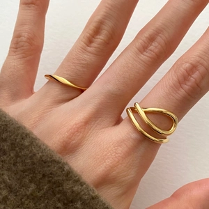 Minimalist gold S925 sterling silver rings with twisted and wave designs on hand