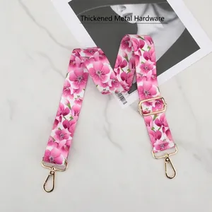Close-up of pink floral pattern bag strap with thickened gold metal swivel hooks