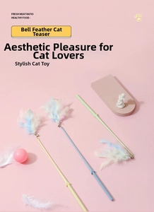 Detailed view of feather cat wand with macaron colors and metal bell on pink stand