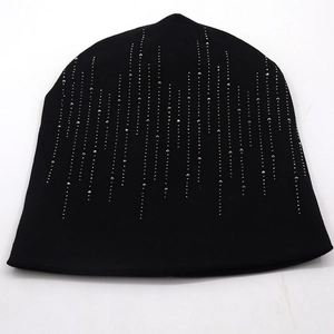 Close-up of black cotton beanie featuring vertical silver rhinestone and bead embellishments