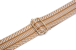 Close-up of adjustable woven shoulder strap with brown chevron pattern and gold metal buckle