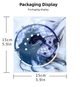 Detail of minimalist dream catcher in packaging with black and white feathers