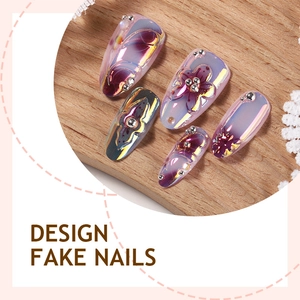 3D floral press-on nails with purple flower art and chrome finish on wooden background