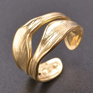 Macro view of gold snake-style ring with lava texture and adjustable open band