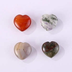 Macro display of four heart-shaped natural gemstones with varied textures on white background