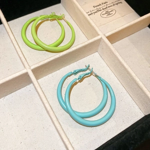Fluorescent green and sky blue large enamel hoop earrings in a jewelry display box