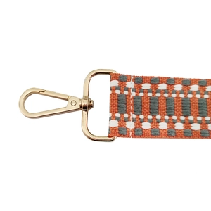 Adjustable geometric patterned orange jacquard bag strap with golden metal swivel hooks