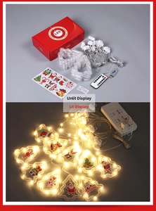 Close-up of LED Christmas string lights with Santa motifs and a wireless remote control