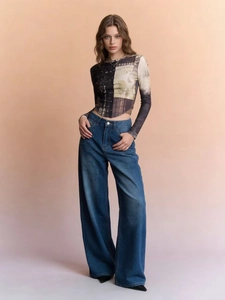 Close-up of vintage printed slim crop top paired with high-waist wide-leg jeans