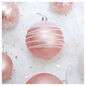 Detail of pink Christmas ball with white flocked stripes and silver hanging loop
