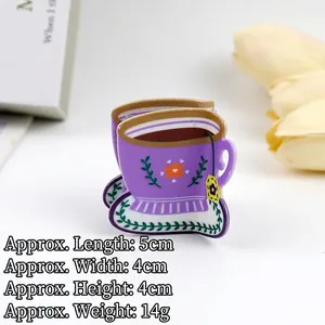 Close-up of cute purple acrylic coffee cup hair claw with flower patterns and green leaf saucer