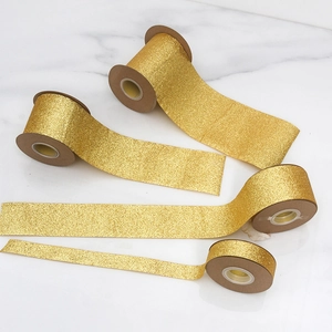 Glittering gold ribbon for Christmas gift wrapping and decor in four varied widths