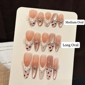 Handmade press-on nails with cat-eye glass beads, white lace patterns and red floral accents
