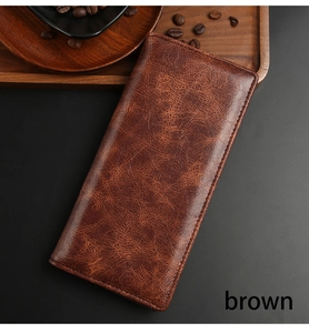 Macro view of textured brown vintage leather long wallet for men on dark background