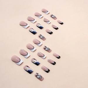 Long ballet style press-on nails with black and white French tips and butterfly accents