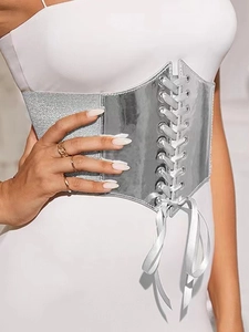 Silver mirror corset belt with lace-up detail worn over a white dress for women