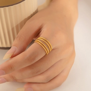 Detail of 18k gold plated multi-layer wrap ring with minimalist geometric design