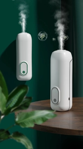 Dual-mode white smart aroma diffuser showing wall-mounted and desktop setup in green scene