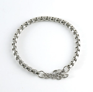 Detail of silver stainless steel box chain bracelet featuring a secure lobster clasp