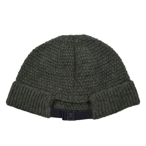 Detail of army green knitted docker cap featuring adjustable nylon strap with buckle