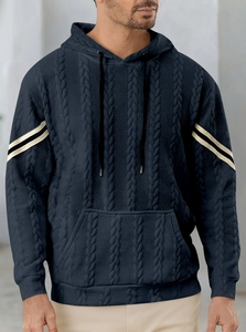 Detail of navy blue hoodie featuring cable knit texture, drawstring hood and kangaroo pocket
