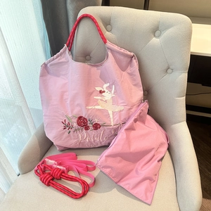 Detailed view of pink nylon organizer bag set featuring ballet bunny and rose embroidery