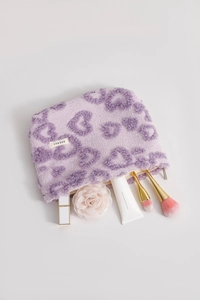 Detailed top view of soft purple heart-textured plush makeup bag with interior storage