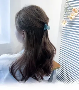 Detailed back view of a teal marble acrylic hair claw clip used for a half-up hairstyle