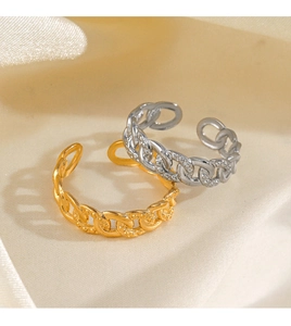 Detail of 18K gold and silver plated chain rings on soft velvet fabric texture