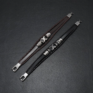Ethnic style woven leather bracelets in black and brown with metal cross accents
