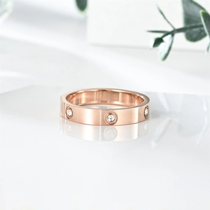 Detail view of a rose gold titanium steel ring with six sparkling inlaid crystals