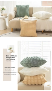 Detailed view of puff textured cream style cushion covers in green and beige tones