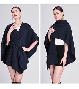 Detail of loose-fit knit poncho cardigan with stylish front tie-up and dark blue drape