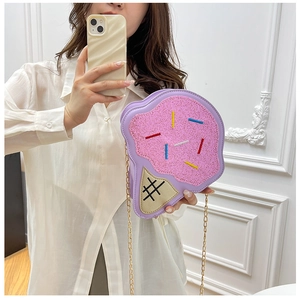 Detail of ice cream cone crossbody bag with pink glitter and golden chain strap
