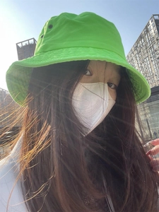 Neon green bucket hat for women providing sun protection in a stylish street style design