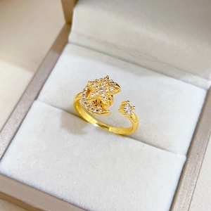 Detailed view of rotating star and moon gold ring with cubic zirconia on jewelry box