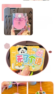Detail view of pink cartoon fishing game keychain with authentic series card and lanyard