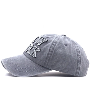 Detail of vintage washed gray baseball cap featuring premium New York 3D embroidery