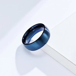 Minimalist 8mm blue matte brushed stainless steel ring on white geometric display stand