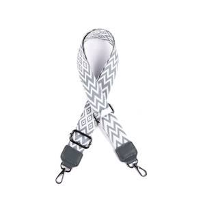 Detail of 38mm grey and white geometric woven strap with silver metal buckles