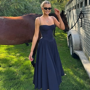 Detail of navy blue backless sundress with fitted bodice in an outdoor lifestyle setting