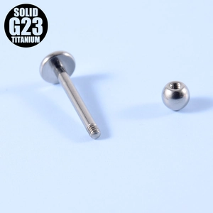 Macro detail of G23 titanium labret stud with internal threading and silver ball head