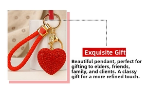 Close-up of a sparkling red heart-shaped keychain with rhinestones and gold ring