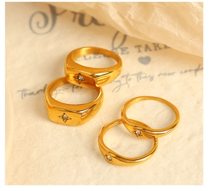 Detail of 18k gold plated stainless steel rings featuring North Star zircon engravings